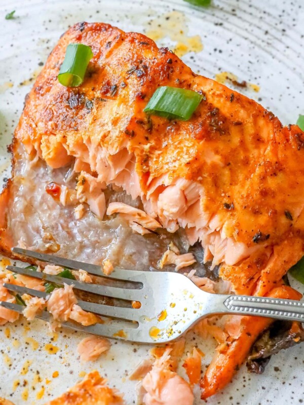 A plate showcasing air-fried jerk salmon with a fork.