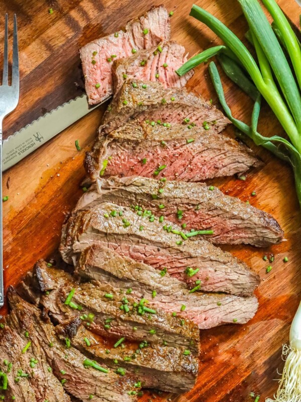 Air fryer London broil served with onions and a fork.