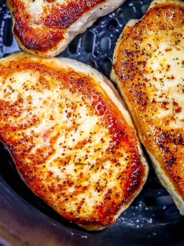 picture of pork chops in an air fryer basket