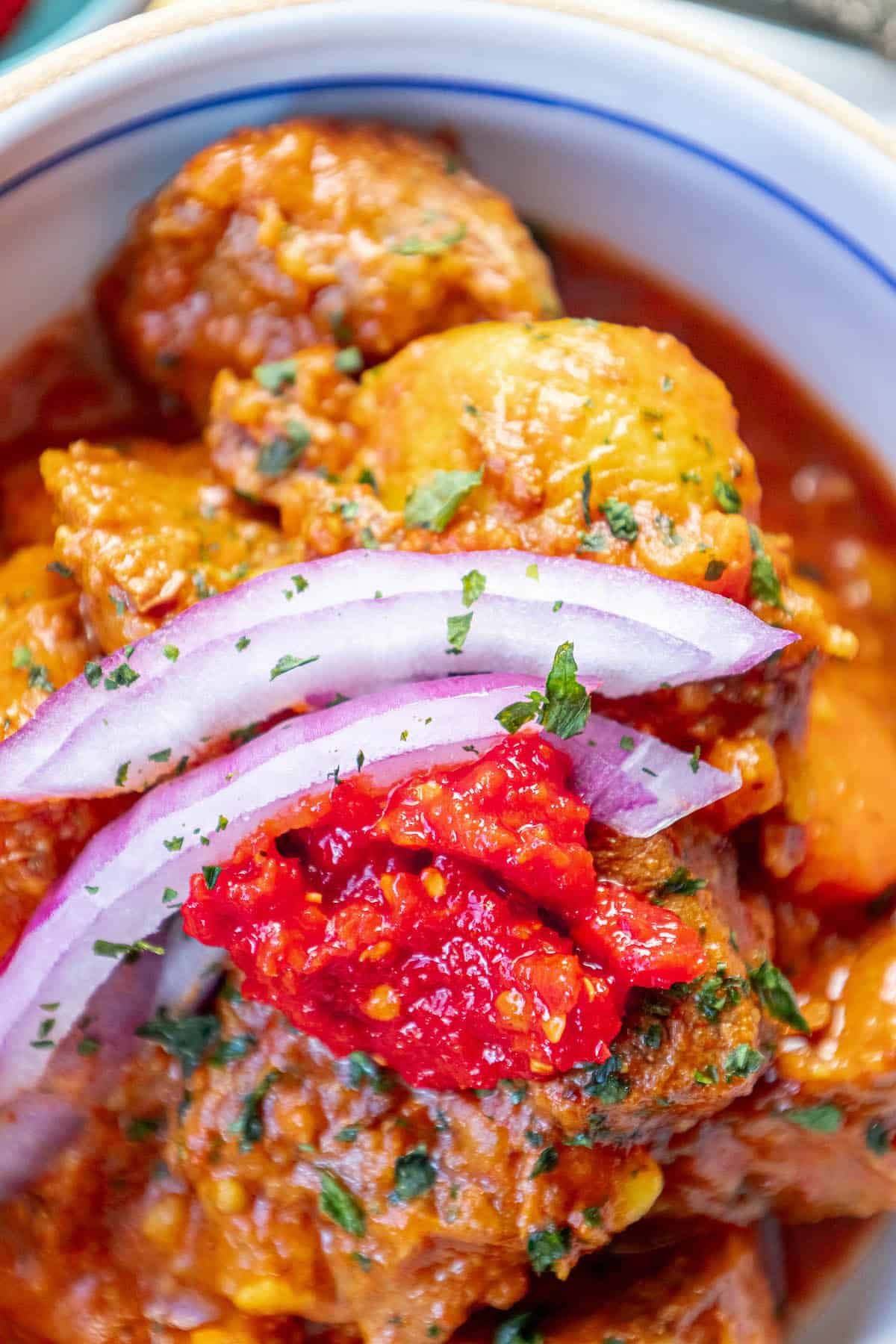 The Best Goulash - A bowl of stew with onions and tomatoes, a delicious and authentic Hungarian beef stew.