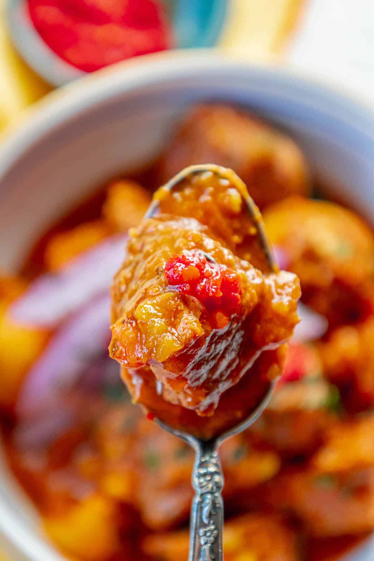 An authentic Hungarian Goulash beef stew with a spoon full of chicken curry in a bowl.