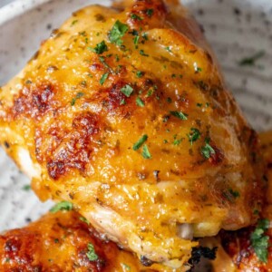 A plate of baked ranch chicken with parsley on it.