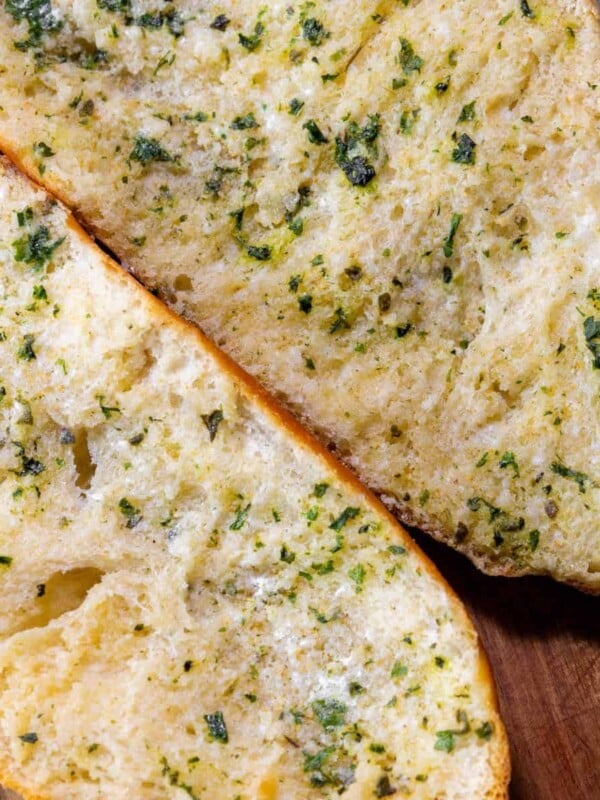 Two slices of easy garlic bread on a cutting board.