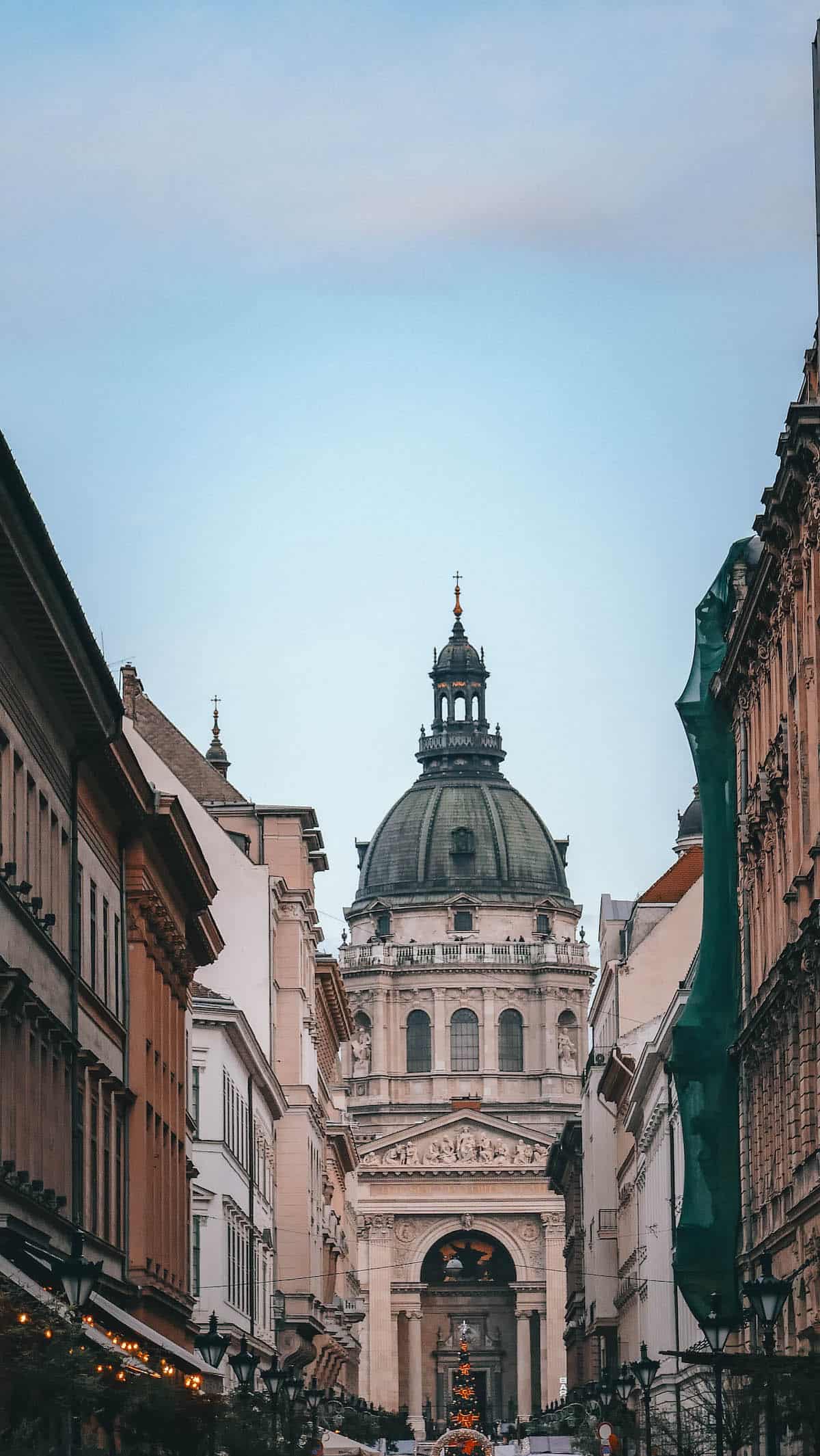 The Best Goulash - A street in a city with buildings and a dome.