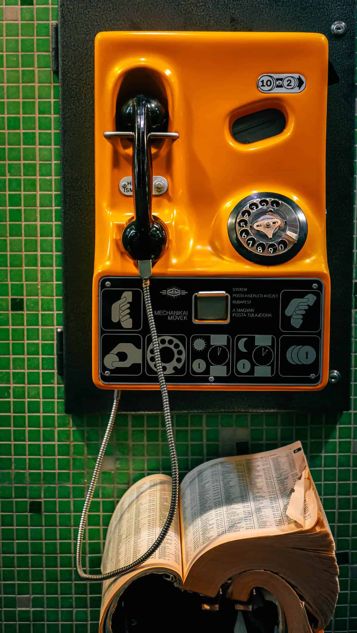 A telephone next to a book.