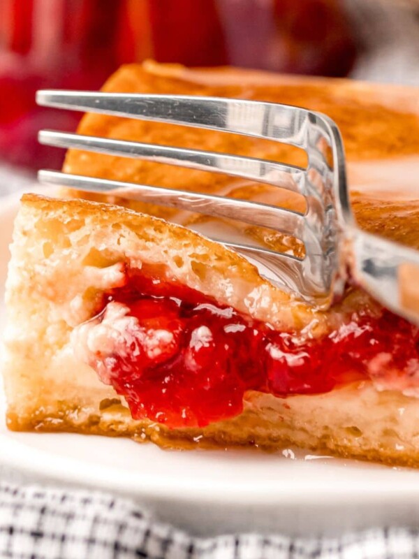 baked cherry cheesecake danish on a white plate