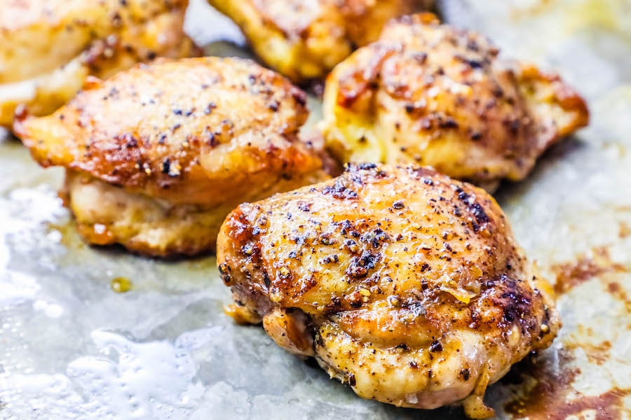 baked chicken thigh on baking sheet