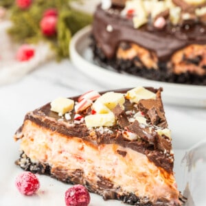 A slice of chocolate peppermint cheesecake on a plate.