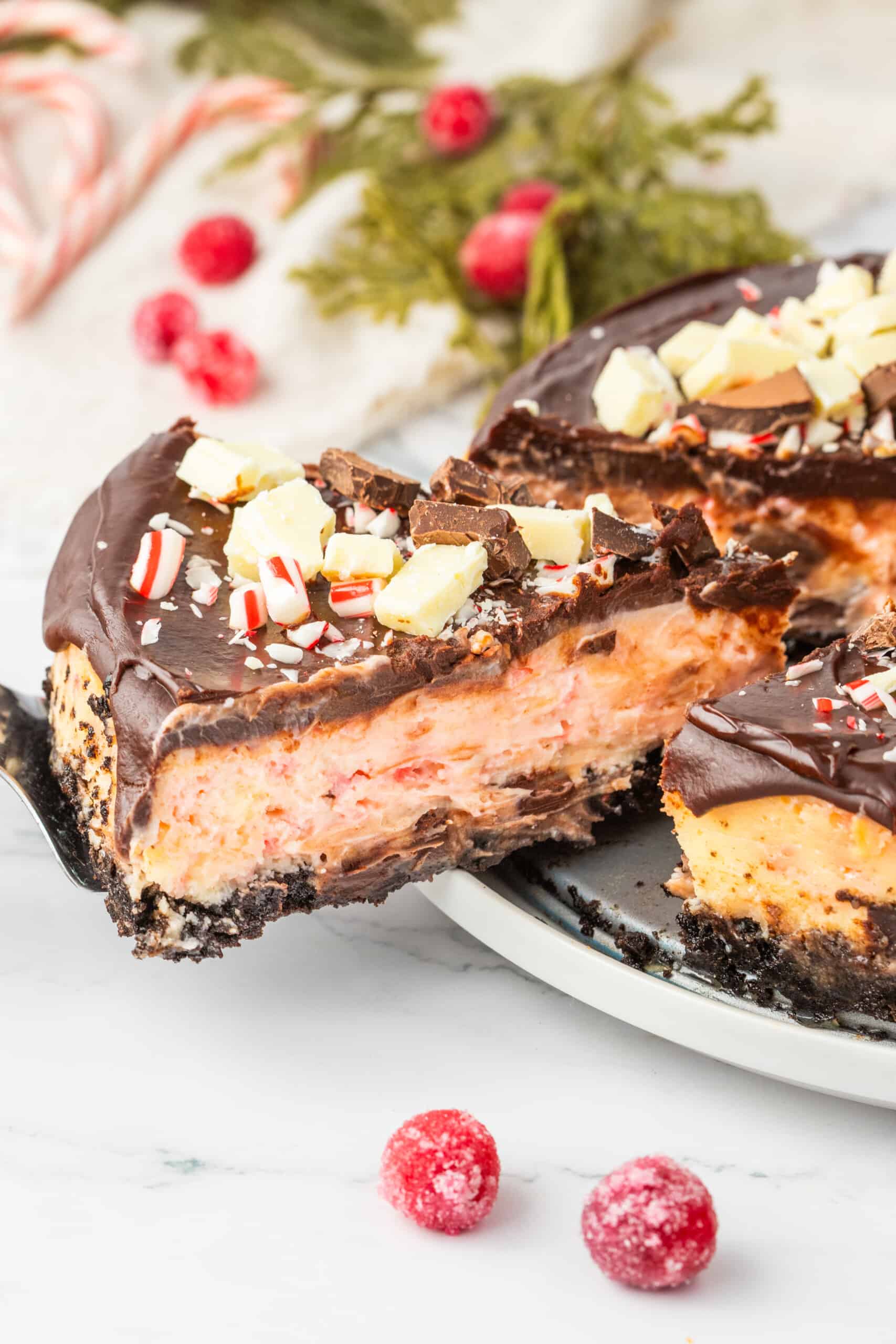 A slice of chocolate peppermint cheesecake on a plate.