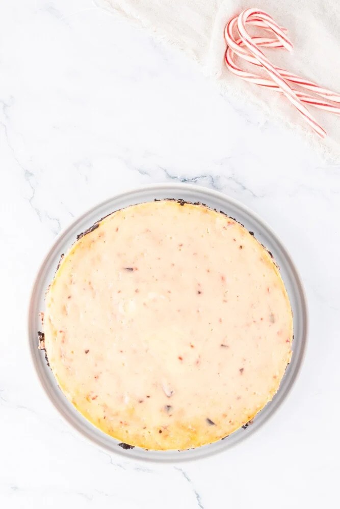 A pie in a pan with candy canes on it.