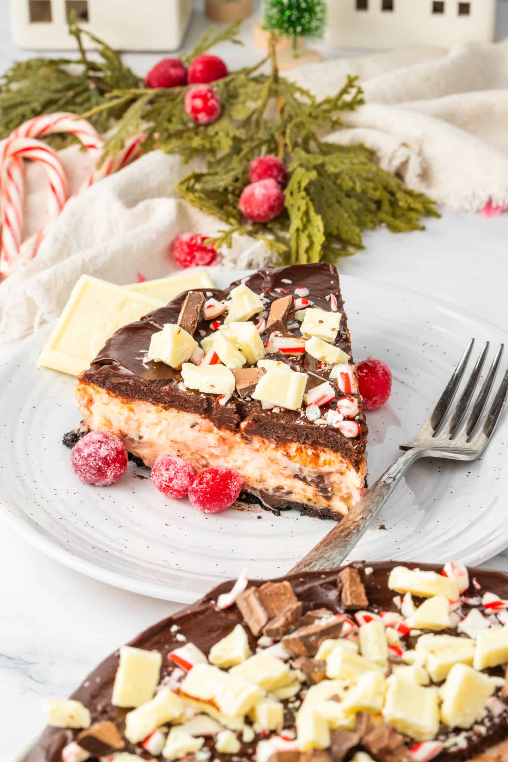 A slice of chocolate peppermint cheesecake on a plate.