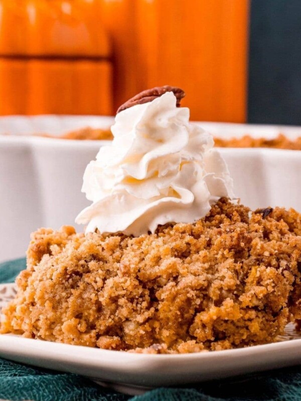 picture of pumpkin crisp on a plate with a drop of whipped cream on top