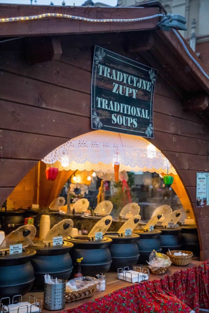 A Krakow food stand showcasing pots of food at the Christmas Market.