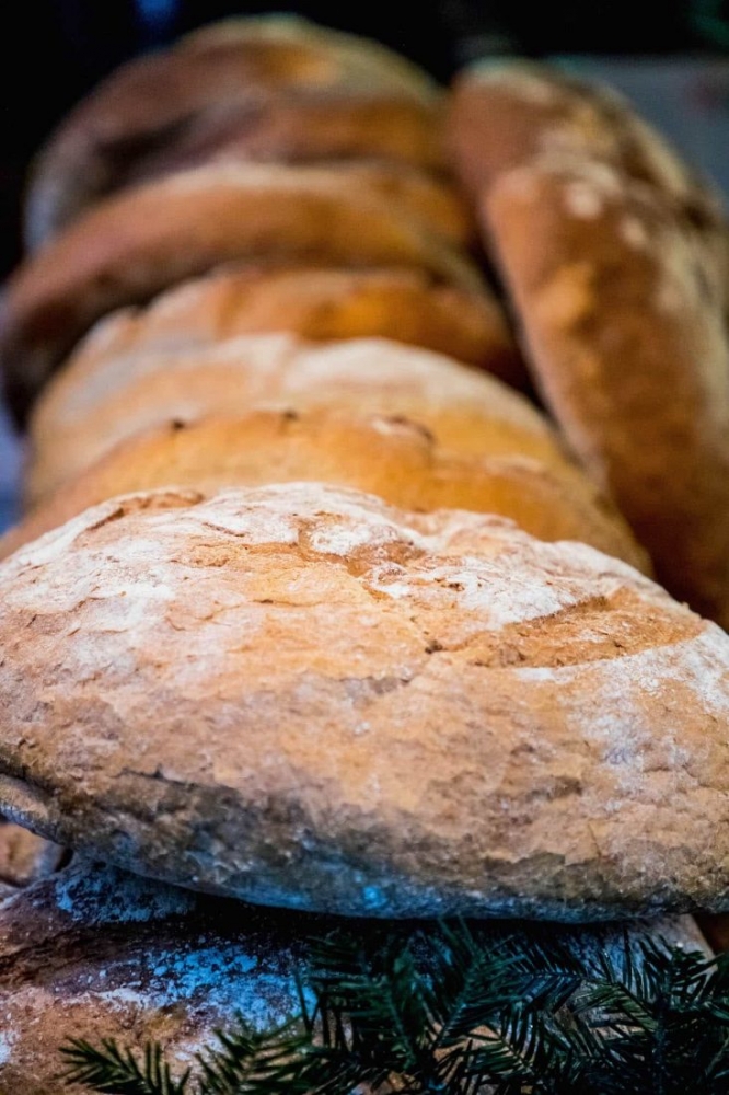 Many loaves of bread are lined up on a table at the Krakow Christmas Market.