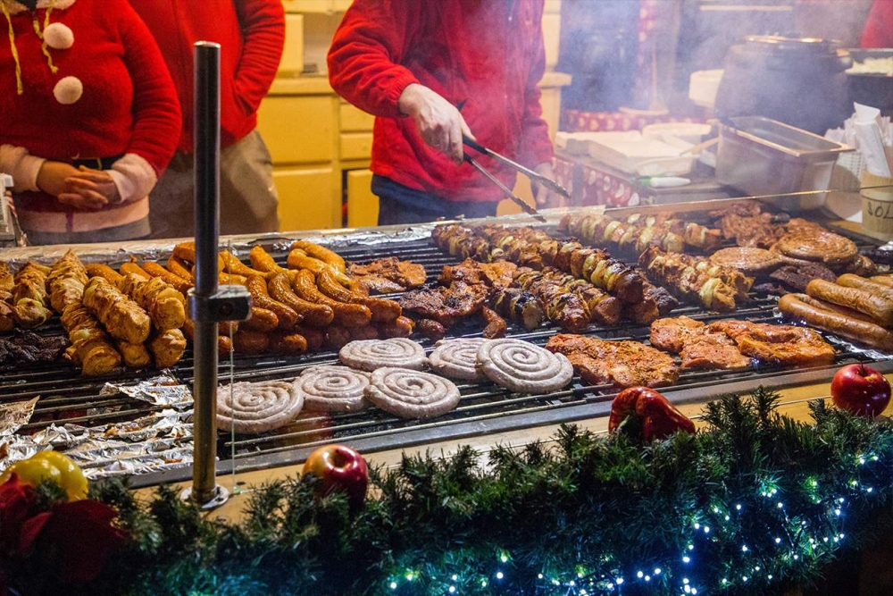 A group of people are preparing food at the Wroclaw Christmas Market.