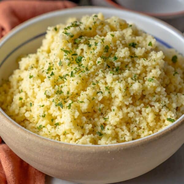 Discover the perfect recipe for a delightful bowl of couscous, garnished with freshly chopped herbs.