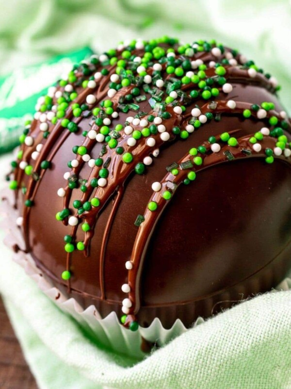 mint chocolate bombs smothered in a cupcake holder with green sprinkles.