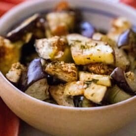 A bowl of roasted eggplant delights, seasoned with aromatic herbs and spices, offers a perfect blend of flavors.