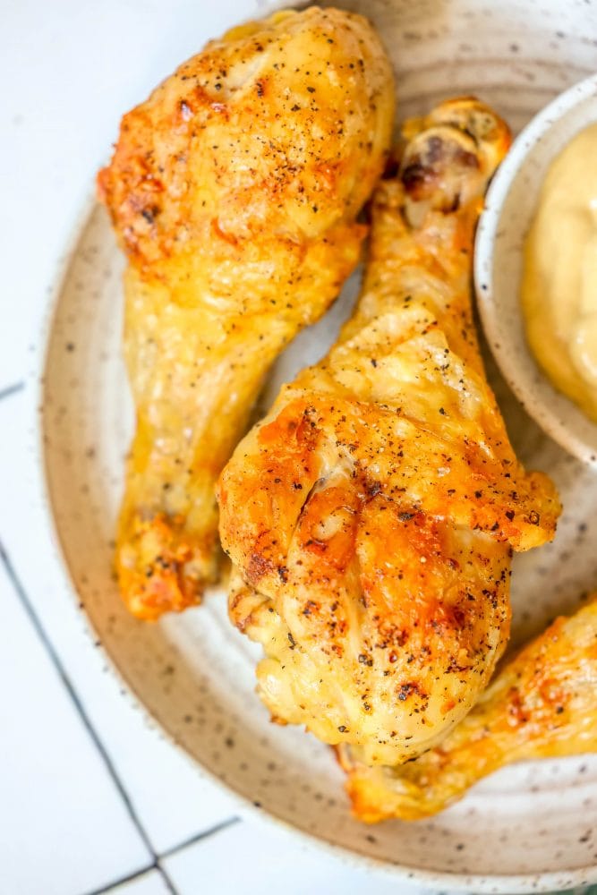 picture of chicken drumsticks on a white plate