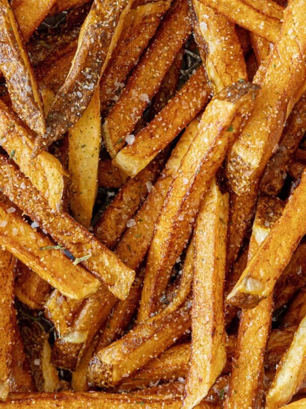 A pile of French fries on a baking sheet.