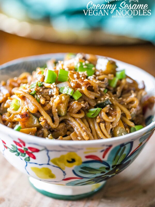 A bowl of tahini noodles with vegetables.